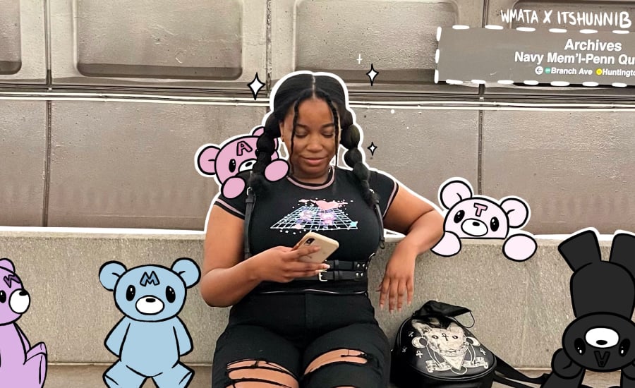 TRIBE creator @itshunnib on a train looking at her phone while surrounded by her hand-drawn illustrations